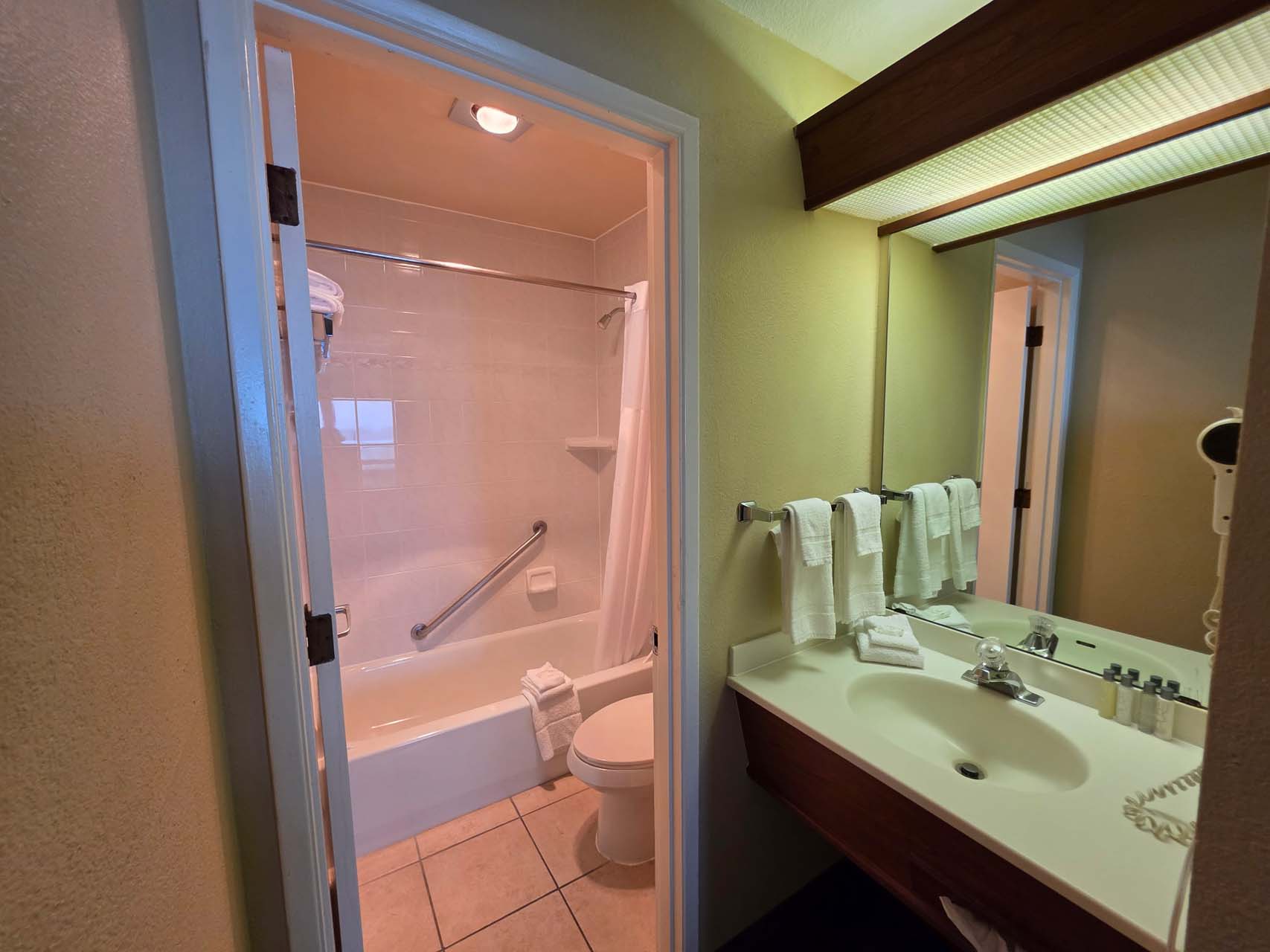 Entry to the guest bathroom next to a sink