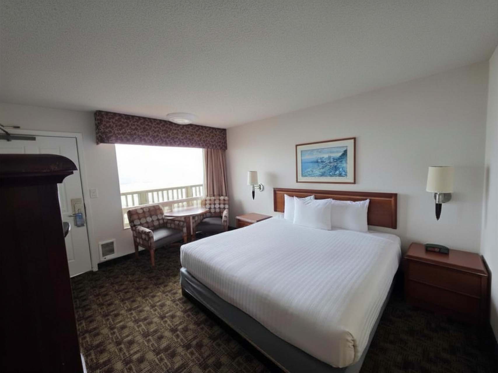 Single King room with a king bed beside a large window